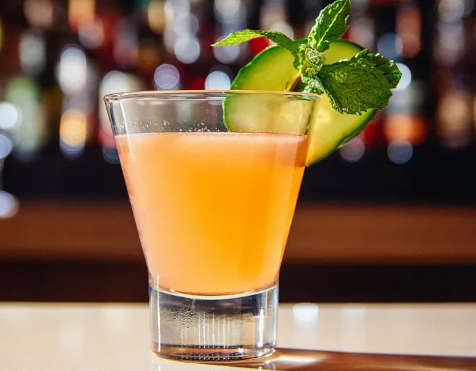 A craft cocktail garnished with cucumber and mint at Bittercreek Alehouse