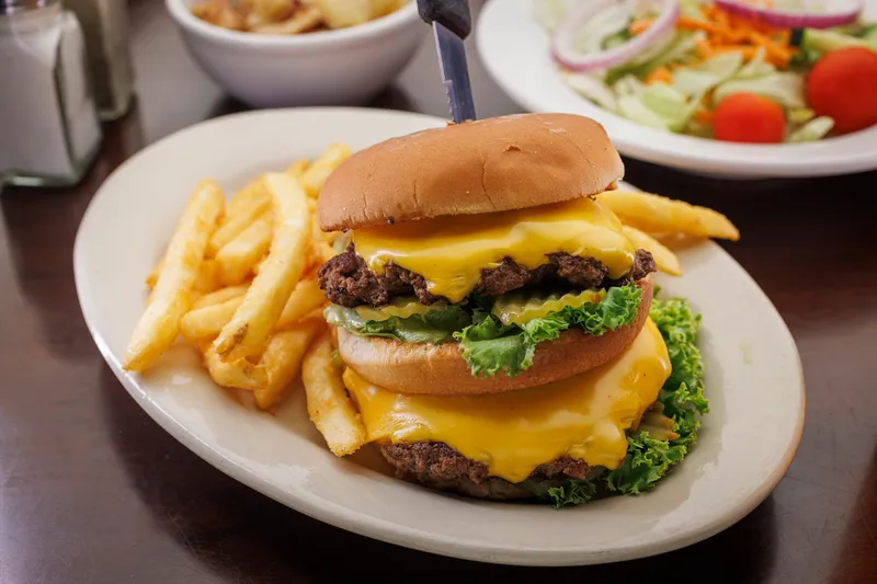 Double cheeseburger with fries and a side salad at Home Plate Cafe & Bakery