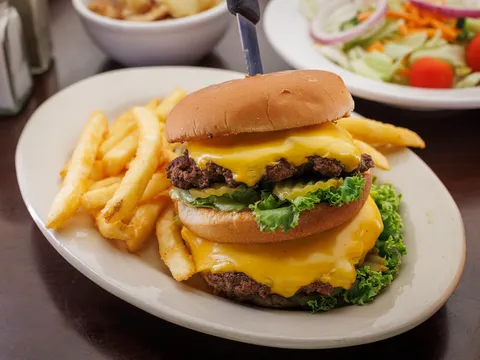 Double cheeseburger with fries and a side salad at Home Plate Cafe & Bakery