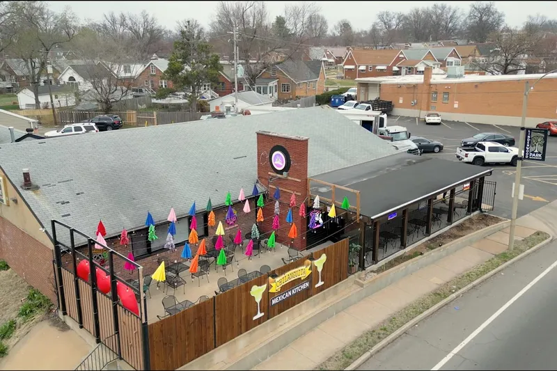Aerial view of Chilanguita Mexican Kitchen on Chippewa Street, showing its patio lined with brightly coloured umbrellas and the restaurant's margarita-glass sign
