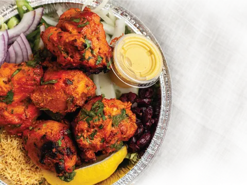 Tandoori chicken platter with rice and pickled onion at Jai Ho Indian Kitchen