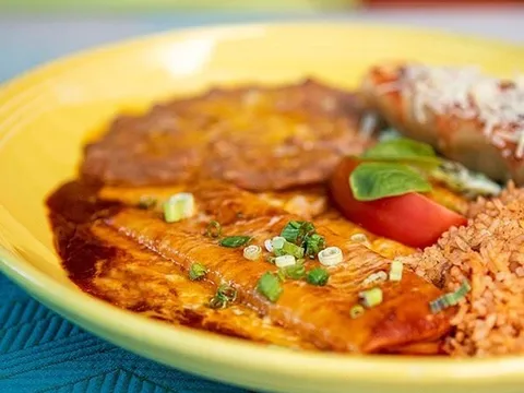 Plated enchilada with rice and beans at El Cholo