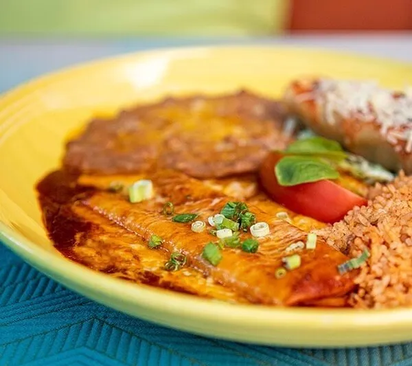Plated enchilada with rice and beans at El Cholo