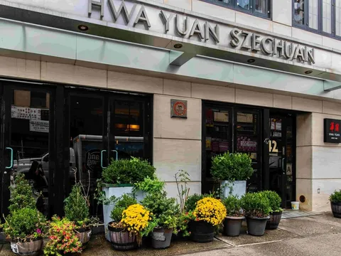 Flower-lined exterior entrance of Hwa Yuan Szechuan in New York