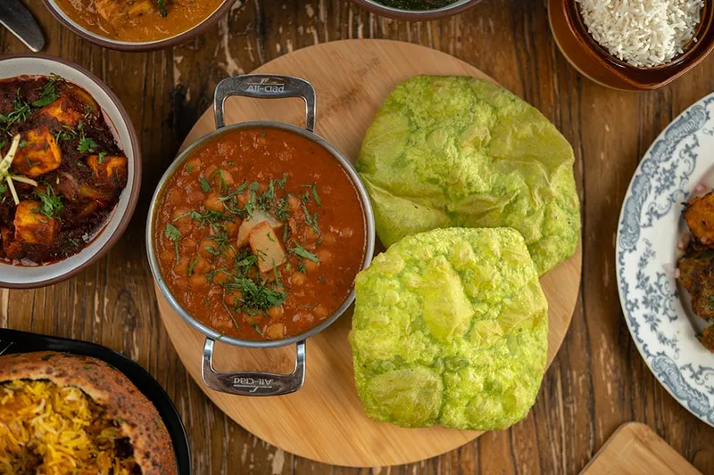 Overhead spread of curries, bhature and rice at Delhi Dhaba