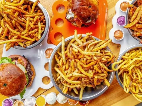 Burgers and bowls of fries with dipping sauces at Boise Fry Company