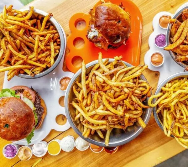 Burgers and bowls of fries with dipping sauces at Boise Fry Company