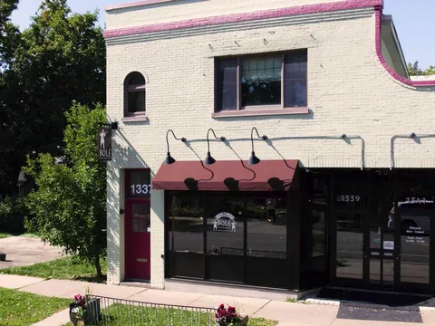Cream-brick storefront of Bolé Ethiopian Cuisine at 1341 Pascal St N, St. Paul, with maroon awnings and posted hours on the door