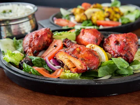 Sizzling tandoori platter with salad, lemon and raita at India Palace