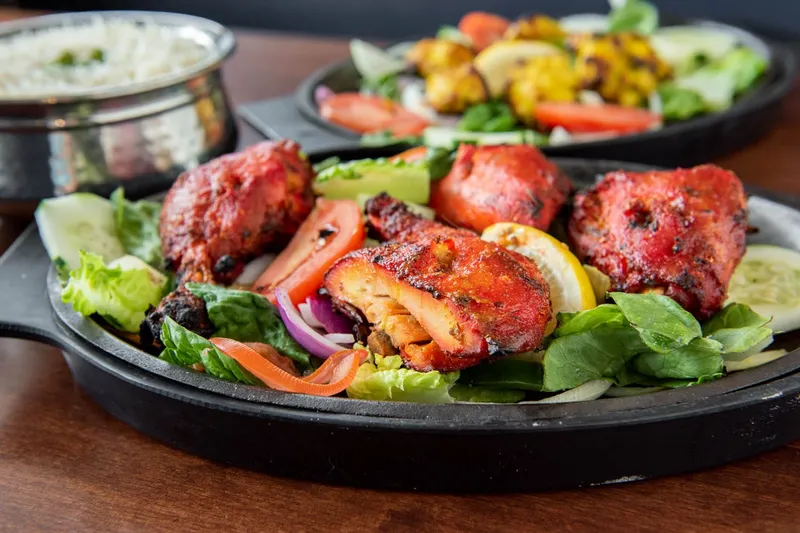 Sizzling tandoori platter with salad, lemon and raita at India Palace
