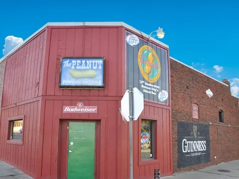Red-painted corner exterior of The Peanut with its neon sign