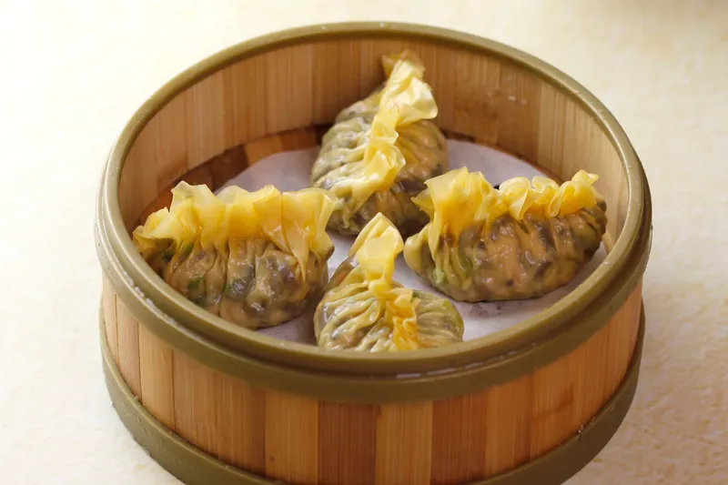 Bamboo steamer of steamed mushroom and vegetable dumplings at Hong Kong Lounge