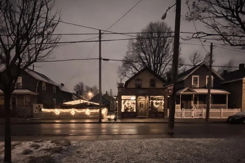 Lucky's Cafe storefront lit up at dusk in Tremont