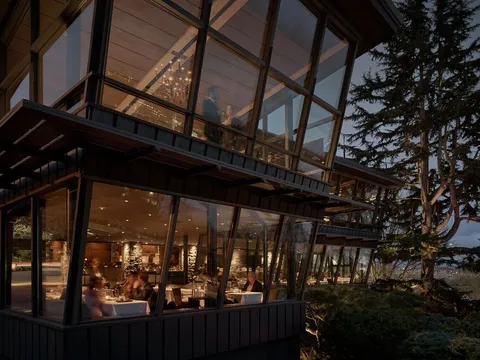 Glass-walled Canlis dining room overlooking Seattle at dusk