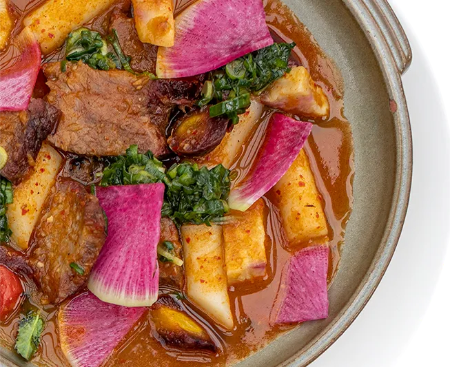Braised short rib and rice cakes with watermelon radish in a rich red sauce at Han Oak in Portland