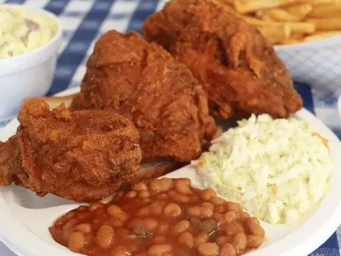 Plate of fried chicken with fries, coleslaw and baked beans at Gus's World Famous Fried Chicken