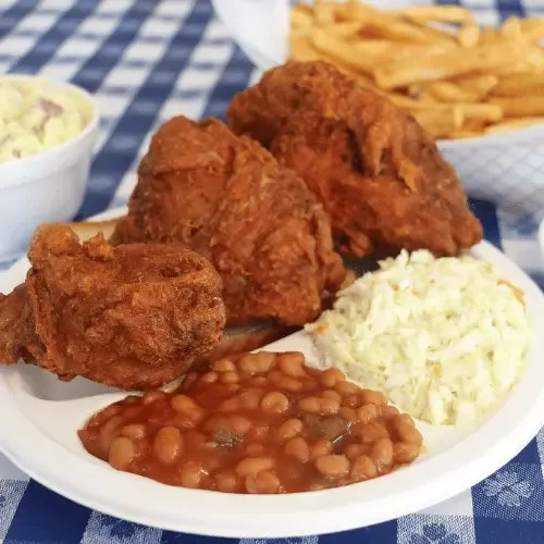 Plate of fried chicken with fries, coleslaw and baked beans at Gus's World Famous Fried Chicken