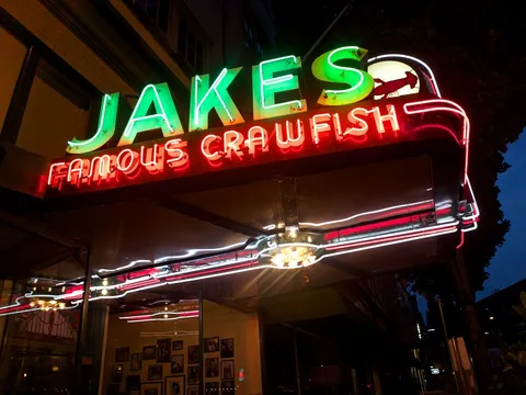 Jake's Famous Crawfish neon storefront sign lit up at night in downtown Portland