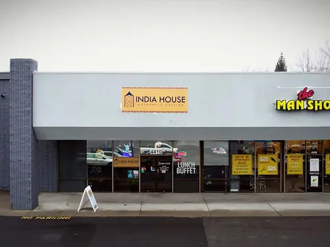 India House storefront in a South Regal Street strip mall in Spokane, with a lunch buffet sign in the window