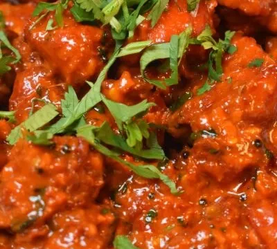 Close-up of a red curry garnished with cilantro at Curry Gate