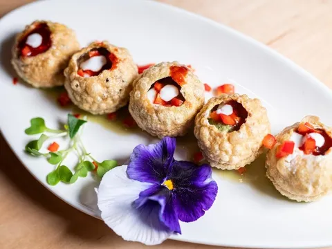Plated pani puri garnished with a pansy at Turmeric Indian Cafe & Bar