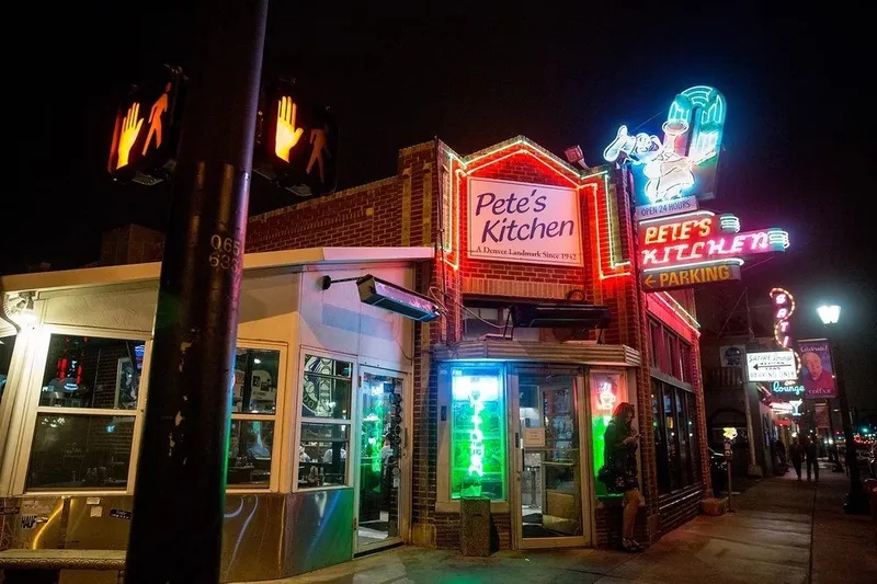 Pete's Kitchen's neon sign lit up at night on East Colfax Avenue