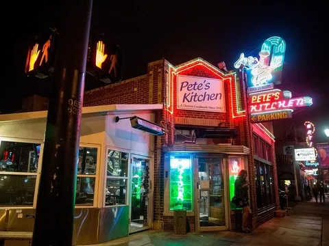 Pete's Kitchen's neon sign lit up at night on East Colfax Avenue