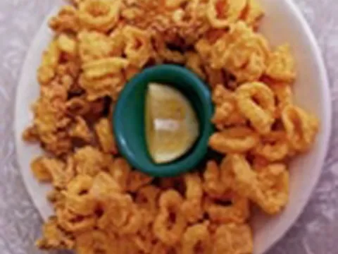 Plate of fried calamari with a lemon wedge at Casamento's Restaurant in New Orleans