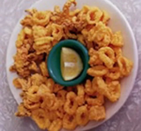 Plate of fried calamari with a lemon wedge at Casamento's Restaurant in New Orleans