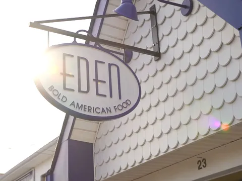Oval sign reading EDEN, Bold American Food, hanging over the shingled facade in Rehoboth Beach