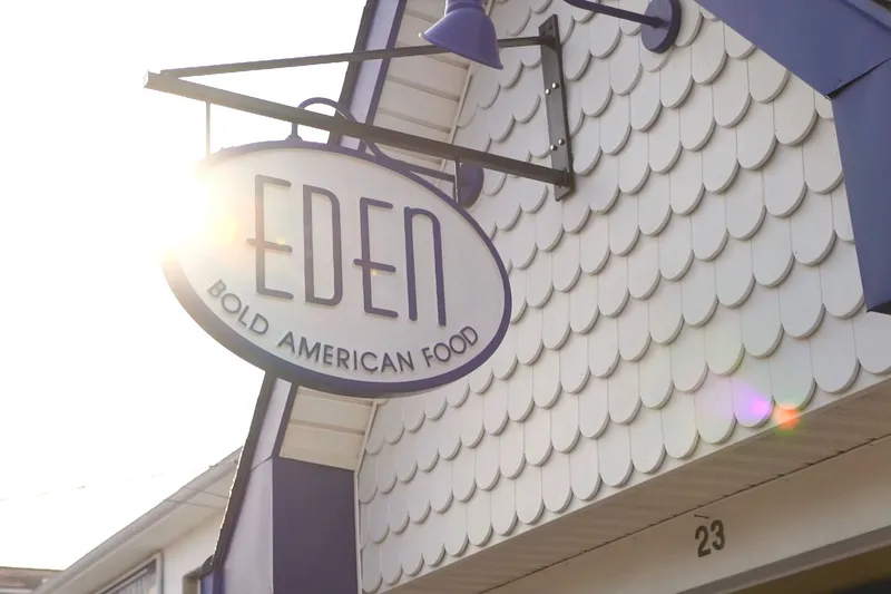Oval sign reading EDEN, Bold American Food, hanging over the shingled facade in Rehoboth Beach