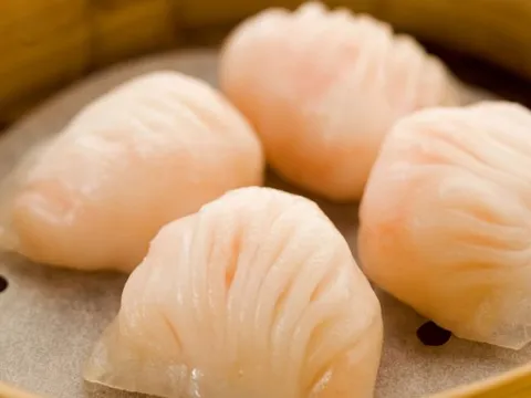 Bamboo steamer of translucent har gow shrimp dumplings at Tim Ho Wan