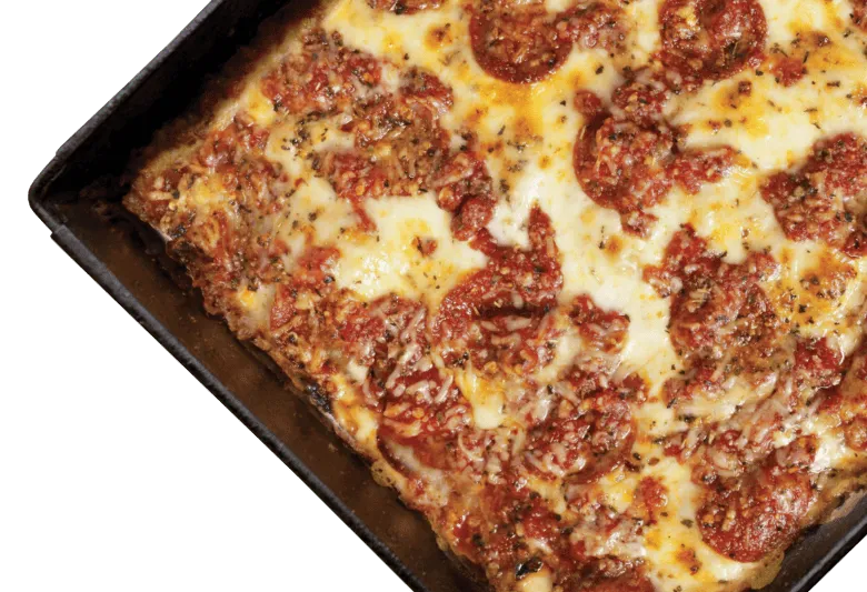 Buddy's Pizza's original Detroit-style square pepperoni pizza with caramelized cheese edges, baked in a seasoned steel pan