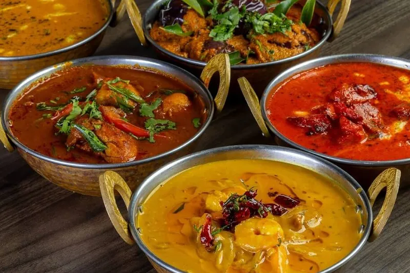 Curries and dal in copper karahi bowls at The Park Indian Restaurant