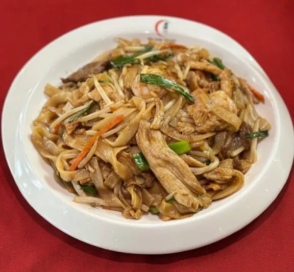 Plate of stir-fried flat rice noodles (chow fun) with sliced meat, bean sprouts and scallions at Lao Sze Chuan