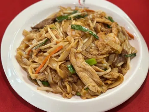 Plate of stir-fried flat rice noodles (chow fun) with sliced meat, bean sprouts and scallions at Lao Sze Chuan