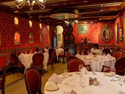 The ornate red-walled Red Room dining room at Columbia Restaurant, set for service