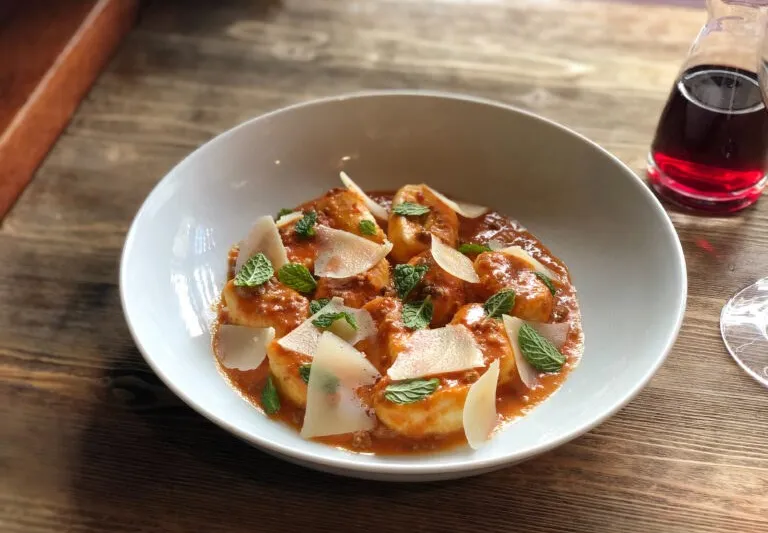 Ricotta gnocchi in tomato sauce with shaved parmesan and mint at FIG