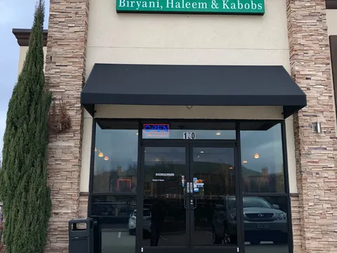 Storefront of Pista House in Irving with the green 'Pista House — Biryani, Haleem & Kabobs' sign above the entrance