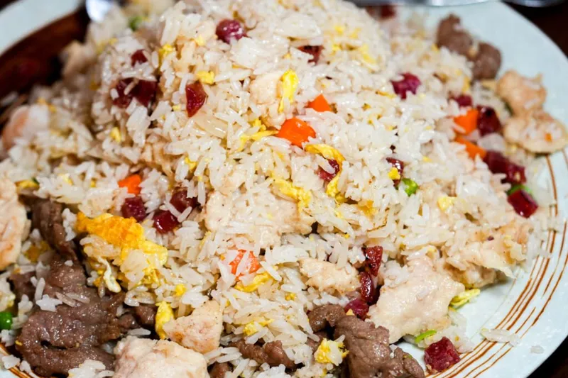 Beijing (川味居)'s signature fried rice studded with char siu, egg, shrimp, chicken, and beef, served on a plate in Salt Lake City's Sugar House