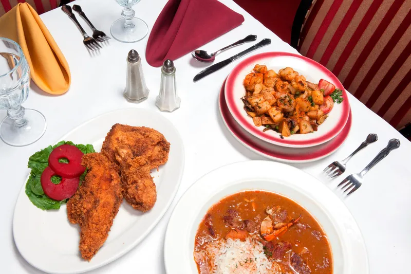 Table set with fried chicken, gumbo, and shrimp and potato salad at Dooky Chase's Restaurant