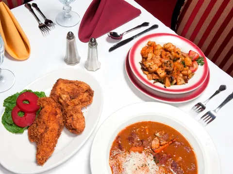 Table set with fried chicken, gumbo, and shrimp and potato salad at Dooky Chase's Restaurant