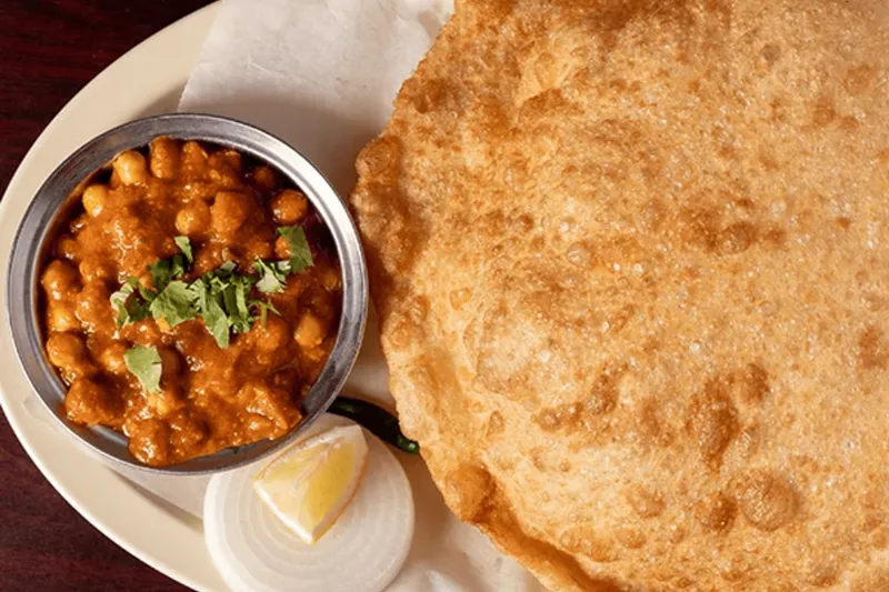 Chana batura — chickpea curry with a large puffed fried batura bread at Udupi Cafe
