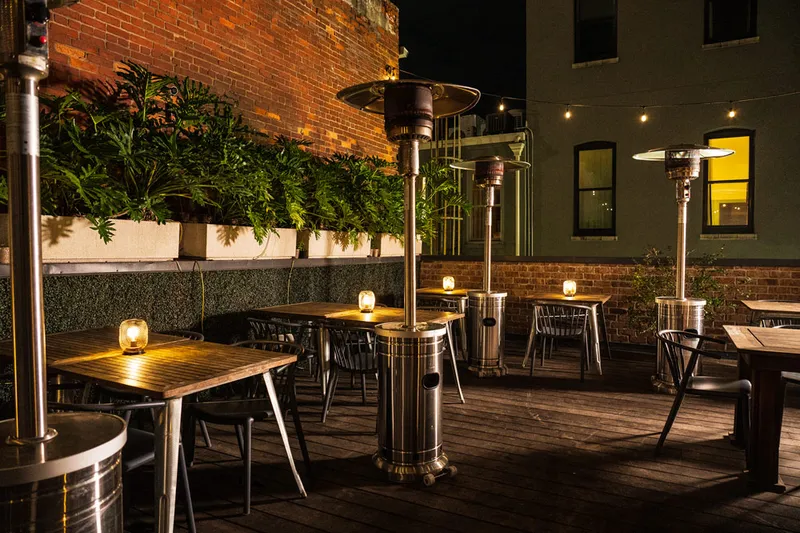 Rooftop patio seating at The Fitzroy at night