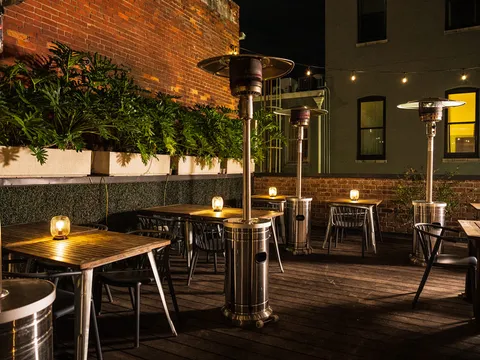 Rooftop patio seating at The Fitzroy at night