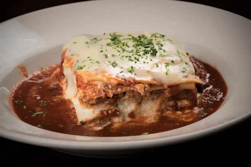 Baked lasagna layered with Italian sausage, beef and ricotta topped with provolone in Maggie's sugo at Garozzo's Ristorante