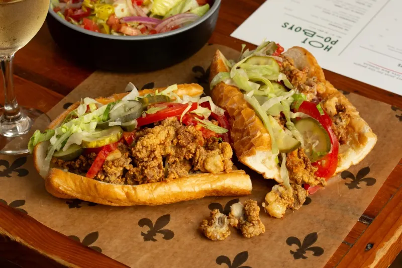 Fried oyster po-boy on Leidenheimer French bread dressed with lettuce, tomato and pickle at Mahony's Po-Boys