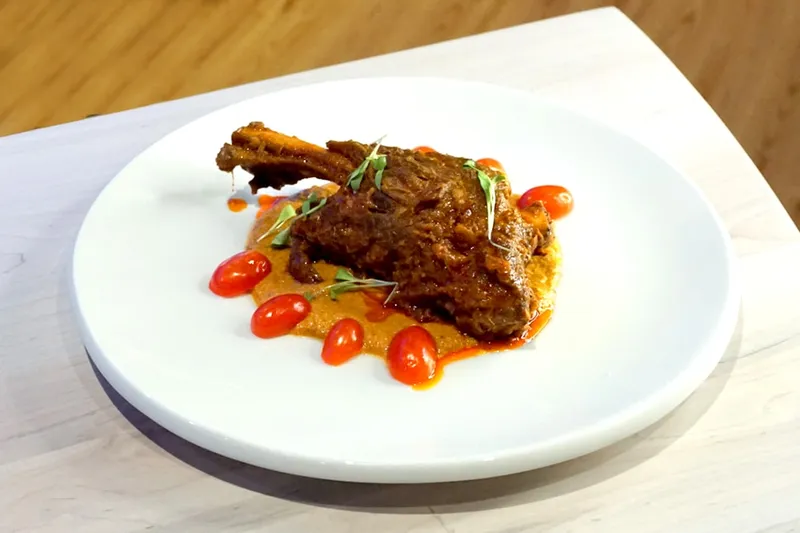 Braised lamb shank curry plated at Deccan Spice in Edison, New Jersey
