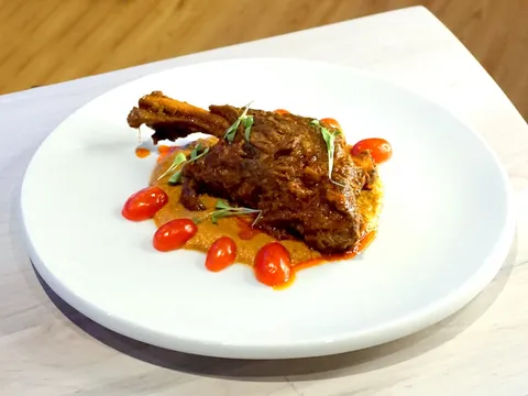Braised lamb shank curry plated at Deccan Spice in Edison, New Jersey