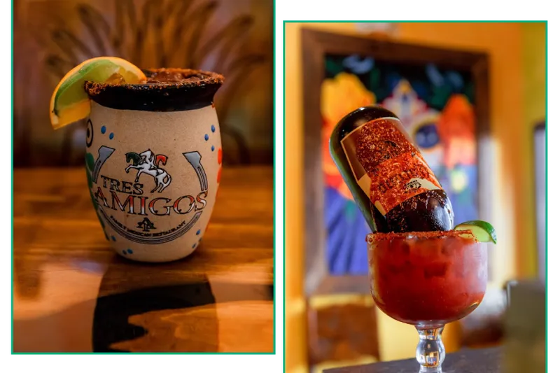 Tres Amigos-branded mug and a garnished michelada served at the bar